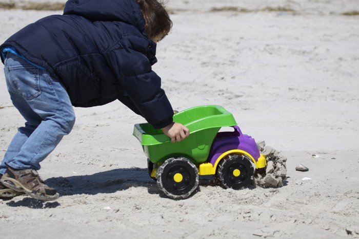 Desi smooshing a sand castle