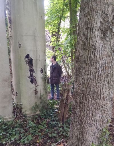 Chuk in a ruined pavilion at Muttontown; pillar with damaged concrete in the foreground