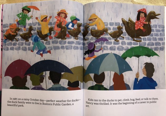 In the rain, a row of happy children sit on, hug and pet the newly installed "Make Way for Ducklings" sculpture in Boston Public Garden, while parents watch from under their umbrellas. 